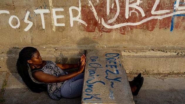 Theatre student Sidumisile Mthethwa goes through her morning exercise routine. Many use the road curbs for step exercises and drainage holes for their feet when doing sit-ups, or they sprint up and down the steep embankment from the bridge down to the railway tracks. (Zinyange Auntony / AFP) Theatre student Sidumisile Mthethwa goes through her morning exercise routine. Many use the road curbs for step exercises and drainage holes for their feet when doing sit-ups, or they sprint up and down the steep embankment from the bridge down to the railway tracks. (Zinyange Auntony / AFP)