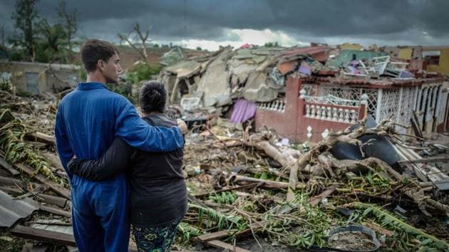 Residents of tornado-hit Regla neighbourhood stand in front of their destroyed house, in Havana, on January 28, 2019.(AFP photo)