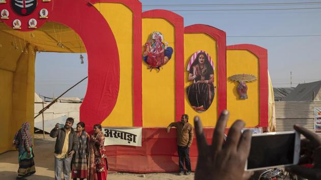 Devotees click pictures at the entrance to "Kinnar akhara," during the Kumbh Mela festival. The Kinnar camp on the edge of the festival grounds is adorned with images of Ardhanari, a half-male, half-female composite of the Hindu god Shiva and his consort Parvati, that religious scholars date to the 1st century. (Bernat Armangue / AP) Devotees click pictures at the entrance to "Kinnar akhara," during the Kumbh Mela festival. The Kinnar camp on the edge of the festival grounds is adorned with images of Ardhanari, a half-male, half-female composite of the Hindu god Shiva and his consort Parvati, that religious scholars date to the 1st century. (Bernat Armangue / AP)
