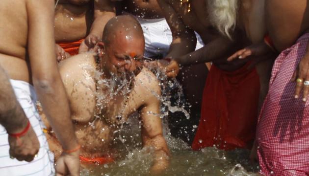 Uttar Pradesh Chief Minister Yogi Adityanath and other leaders take holy dip at Kumbha Mela on Tuesday.