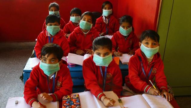 Students wearing masks as protection against Swine flu, attend a class at a school in Ajmer. Rajasthan is the worst affected state by the swine flu with at least 1,911 cases being reported as of January 27. The state has witnessed 75 deaths in the past one month. Health minister Raghu Sharma has ordered intensive screening of swine flu suspects at bus stands and railway stations across the state. (PTI)