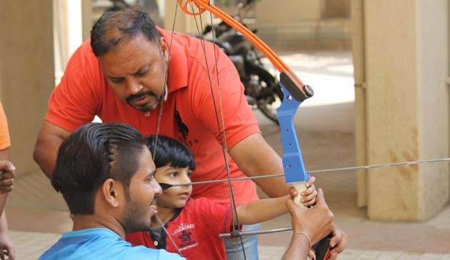 A former compound national archer, Sanand Mitra (in red T-shirt) launched in Pune the first public archery competition - the Iron Target challenge - where he wanted people to come and enjoy the sport.(HT PHOTO)