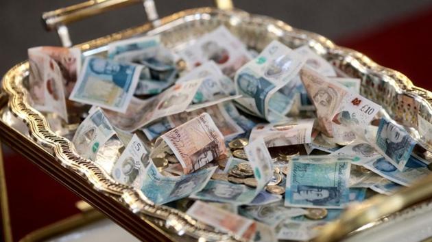 Sterling notes seen on a collection tray during a Good Friday Lent church service. Southwark represents the biggest concentration of African Christians in the world outside the continent with an estimated 20,000 congregants attending churches each Sunday, according to researchers at the University of Roehampton. (Simon Dawson / REUTERS) Sterling notes seen on a collection tray during a Good Friday Lent church service. Southwark represents the biggest concentration of African Christians in the world outside the continent with an estimated 20,000 congregants attending churches each Sunday, according to researchers at the University of Roehampton. (Simon Dawson / REUTERS)