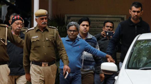 Rajiv Saxena (C), an accused in India's abortive, scandal-tainted helicopter deal with Anglo-Italian firm Agusta Westland, is escorted by police as he leaves a court in New Delhi, India, January 31, 2019.(Reuters)