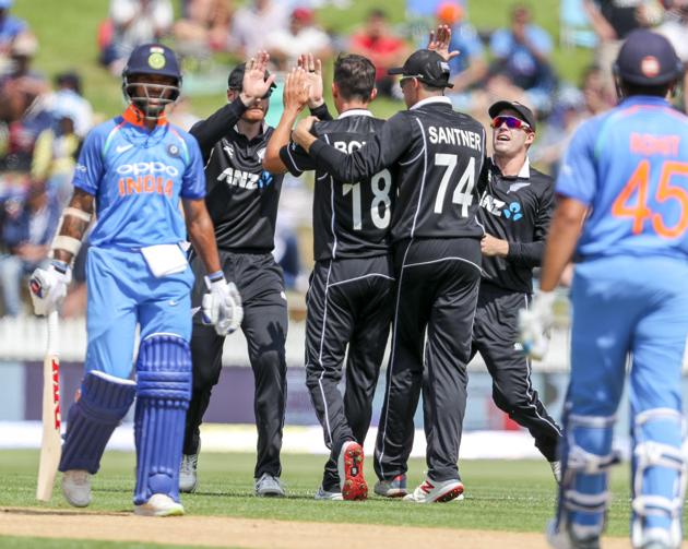 New Zealand celebrates the wicket of India's Shikhar Dhawan, left, during their fourth one day international cricket match at Seddon Park in Hamilton. (AP) 