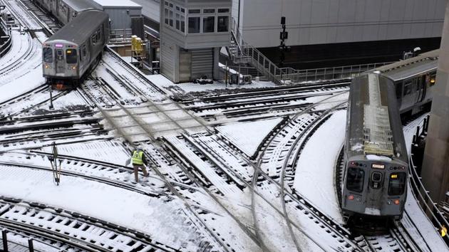 Chicago’s El trains move along snow-covered tracks, in Chicago, Illinois. (Kiichiro Sato / AP)