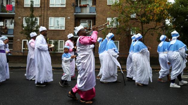 Members of the Eternal Sacred Order of Cherubim & Seraphim Church parade to celebrate their annual Thanksgiving. The congregation, almost entirely dressed in white robes, steadily grew to around 70 people as musicians playing drums, a keyboard and a guitar picked up the pace of the hymns. Some women prostrated themselves in prayer. (Simon Dawson / REUTERS) Members of the Eternal Sacred Order of Cherubim & Seraphim Church parade to celebrate their annual Thanksgiving. The congregation, almost entirely dressed in white robes, steadily grew to around 70 people as musicians playing drums, a keyboard and a guitar picked up the pace of the hymns. Some women prostrated themselves in prayer. (Simon Dawson / REUTERS)