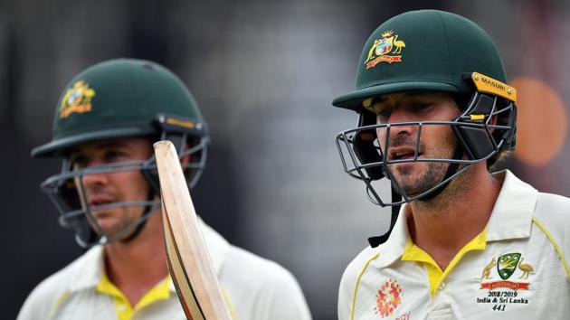 Australia's Joe Burns (R) and Travis Head walk back to the pavilion during a tea break on day one of the second Test cricket match between Australia and Sri Lanka at Manuka Oval Cricket Ground in Canberra on February 1, 2019.(AFP)