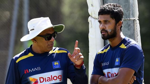 File image: Sri Lanka's Dinesh Chandimal (R) speaks with coach Chandika Hathurusingha during a practice session.(AFP)