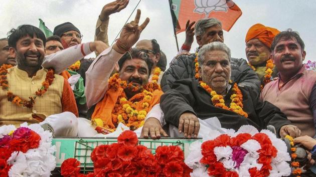 BJP candidate Krishan Middha with the party leader Krishna Lal Panwar during a victory rally after winning the Jind Assembly seat, in Jind, Thursday, Jan 31, 2019.(PTI)