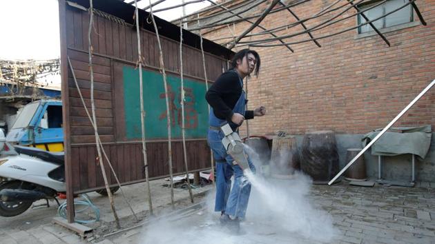 Geng Shuai poses to dance with a device that creates theatrical fog with flour. Now Geng earns about three times what he used to, he said, despite poor sales and prices seen as high, because each specialised item takes a long time to make by hand. His earnings come mainly from online tokens bought by followers and advertisements embedded in his videos. (Jason Lee / REUTERS) Geng Shuai poses to dance with a device that creates theatrical fog with flour. Now Geng earns about three times what he used to, he said, despite poor sales and prices seen as high, because each specialised item takes a long time to make by hand. His earnings come mainly from online tokens bought by followers and advertisements embedded in his videos. (Jason Lee / REUTERS)