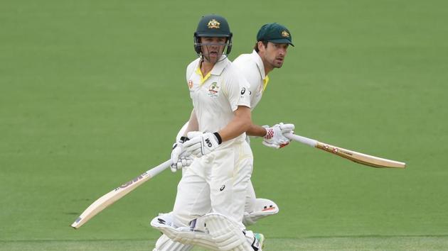 Australia's Travis Head (L) and Joe Burns run between the wickets during the first day of the second and final Test cricket match between Australia and Sri Lanka at the Manuka Oval in Canberra.(AFP)