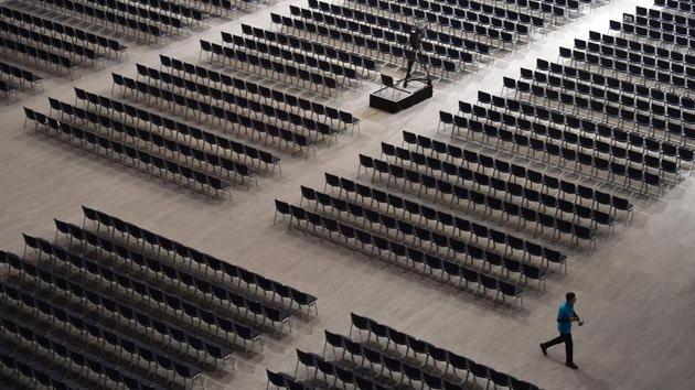 An employee walks between seats ahead of the Siemens company’s annual shareholder’s meeting in the Olympic hall in Munich, southern Germany. (Christof Stache / AFP)