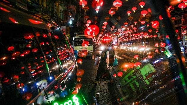 People walk under decorative lanterns ahead of the Chinese New Year in Yangon’s Chinatown district. (Ye Aung Thu / AFP)
