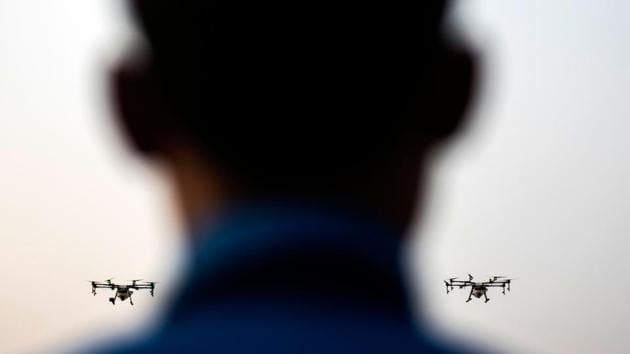 A volunteer for the Bangkok Metropolitan Administration flies a drone fitted with a water tank during a demonstration to make artificial rain to tackle air pollution in Bangkok, Thailand. The Thai capital has been shrouded in murky haze for weeks, sparking social media criticism of the uneven response by the government. (Jewel Samad / AFP)