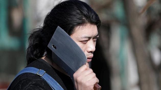 Geng Shuai, poses with an invention, a mobile phone case in the shape of a cleaver, outside his workshop. Geng’s creative mind is a joy to watch, said Zhou Bingke, who teaches welding and metalwork at Tsinghua University. (Jason Lee / REUTERS) Geng Shuai, poses with an invention, a mobile phone case in the shape of a cleaver, outside his workshop. Geng’s creative mind is a joy to watch, said Zhou Bingke, who teaches welding and metalwork at Tsinghua University. (Jason Lee / REUTERS)