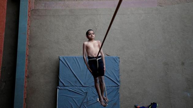 A participant practices “Mallakhamb” (traditional Indian gymnastics) while suspended from a rope during a practice session for the upcoming competition to promote the sport, in Ahmedabad, Gujarat. (Amit Dave / REUTERS)