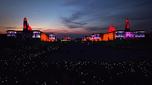 Members of the audience wave their mobile phones to add light to the illuminated Raisina Hills, during the Beating Retreat ceremony at Vijay Chowk in New Delhi. (Mohd Zakir / HT Photo)