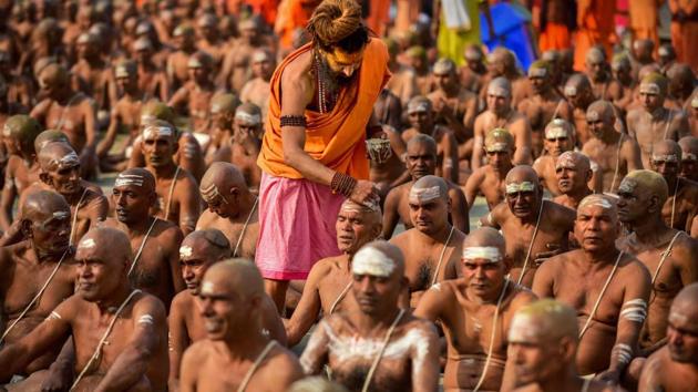 Newly initiated ‘Naga Sadhus’ perform rituals on the bank of river Ganga, during Kumbh Mela in Prayagraj. (PTI)