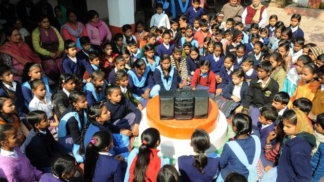 Students listen to the radio during Prime Minister Narendra Modi’s interactive session ‘Pariksha Pe Charcha 2.0,’ at Government Girls Middle School, in Patna, Bihar. (AP Dube / HT Photo)