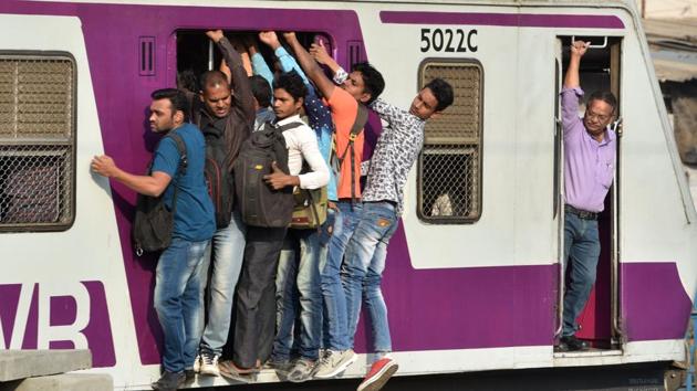 Commuters seen travelling from Borivali to Churchugate in a the crowed local train at Goregaon in Mumbai, Maharashtra. (Satyabrata Tripathy / HT Photo)