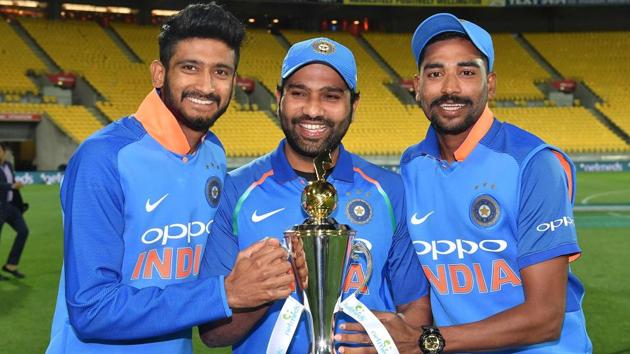 India's Khaleel Ahmed (L) with teammates Rohit Sharma (C) and Mohammed Siraj (R) pose with the trophy. (AFP)