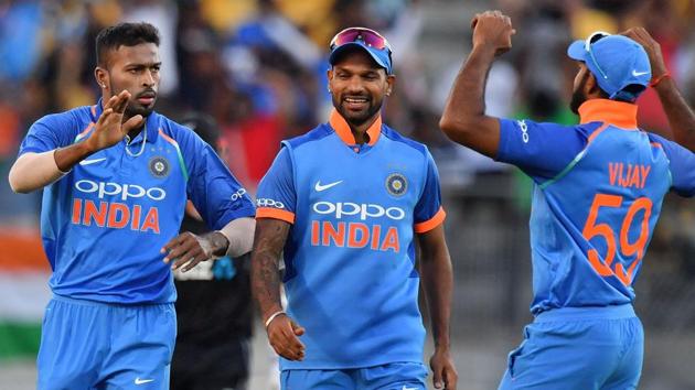 India's Hardik Pandya (L) celebrates with teammates Shikhar Dhawan (C) and Vijay Shankar (R).(AFP)