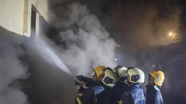 Fire fighers try to douse the fire that broke out in Sadhana house near BDD Chawl, Worli in Mumbai, on December 29, 2018.(HT FILE)