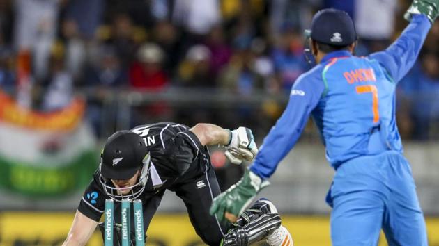 India's MS Dhoni, right, runs out New Zealand's James Neesham during their fifth one day international at Westpac Stadium in Wellington.(AP)