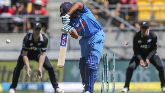 India's Rohit Sharma, center, is bowled by New Zealand's Henry Nicholls. (AP)