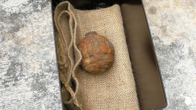 TOPSHOT - This handout photograph taken on February 2, 2019 and released February 3 by the Hong Kong Police Force shows World War I-era German hand grenade that was found among a shipment of French potatoes bound for a potato chips factory, in Hong Kong. - A German World War I hand grenade was found among a shipment of French potatoes imported for a Hong Kong crisp factory, police said. The grenade is believed to have been left in a trench during World War I and accidentally gathered up with potatoes planted a century later in the former battlefield..(AFP)