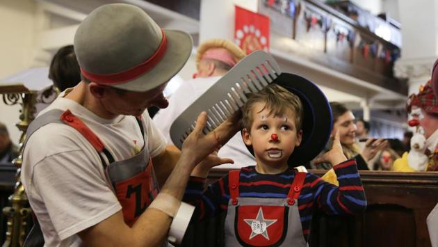 Clowns perform inside the church. The unusual gathering attracted puzzled looks and enthusiastic fans. “People stop you for autographs,” Bibbledy Bob remarked. “If I told you that David Beckham was coming today, you’d totally believe me, there’s paparazzi from all over the world.” (Daniel Leal-Olivas / AFP) Clowns perform inside the church. The unusual gathering attracted puzzled looks and enthusiastic fans. “People stop you for autographs,” Bibbledy Bob remarked. “If I told you that David Beckham was coming today, you’d totally believe me, there’s paparazzi from all over the world.” (Daniel Leal-Olivas / AFP)