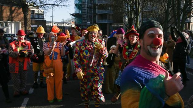 Clowns walk to the church for the memorial service. “King of clowns” Grimaldi was a 19th century English stage performer, and is recognized as having invented the look that came to define the role of a clown. (Daniel Leal-Olivas / AFP) Clowns walk to the church for the memorial service. “King of clowns” Grimaldi was a 19th century English stage performer, and is recognized as having invented the look that came to define the role of a clown. (Daniel Leal-Olivas / AFP)