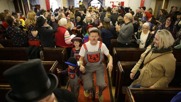 Ballons and bunting hung above the normally sombre pews, which were taken over by wags wearing tiny hats, huge bow ties and novelty flowers in honour of the English actor and comedian, who lived from 1778 to 1837. (Daniel Leal-Olivas / AFP) Ballons and bunting hung above the normally sombre pews, which were taken over by wags wearing tiny hats, huge bow ties and novelty flowers in honour of the English actor and comedian, who lived from 1778 to 1837. (Daniel Leal-Olivas / AFP)