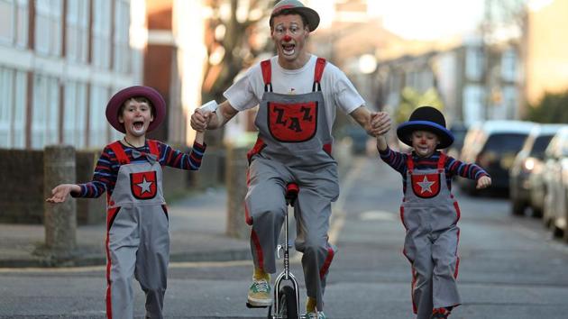 A clown on a unicycle performs for visitors before the 73rd annual Grimaldi Memorial Service at the All Saints church in east London. The streets of east London were awash with a surreal splash of colour on Sunday as clowns from across the world gathered for the annual memorial of the legendary Joseph Grimaldi. (Daniel Leal-Olivas / AFP) A clown on a unicycle performs for visitors before the 73rd annual Grimaldi Memorial Service at the All Saints church in east London. The streets of east London were awash with a surreal splash of colour on Sunday as clowns from across the world gathered for the annual memorial of the legendary Joseph Grimaldi. (Daniel Leal-Olivas / AFP)