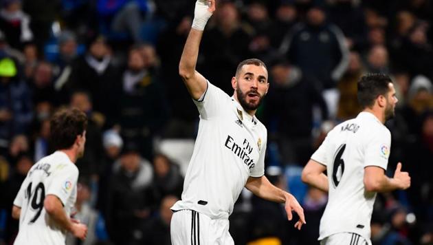 Real Madrid's French forward Karim Benzema celebrates scoring the opening goal during the Spanish league football match Real Madrid CF against Club Deportivo Alaves at the Santiago Bernabeu stadium(AFP)