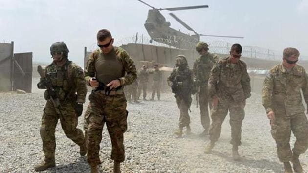 US army soldiers walk as a NATO helicopter flies overhead. (AFP file photo) US army soldiers walk as a NATO helicopter flies overhead. (AFP file photo)