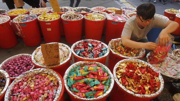 A vendor packs candies at the Dihua Street market in Taipei, Taiwan. Taiwanese shoppers started hunting for delicacies, dried goods, and other bargains at the market weeks ahead of the Lunar New Year celebrations. (Chiang Ying-ying / AP) A vendor packs candies at the Dihua Street market in Taipei, Taiwan. Taiwanese shoppers started hunting for delicacies, dried goods, and other bargains at the market weeks ahead of the Lunar New Year celebrations. (Chiang Ying-ying / AP)