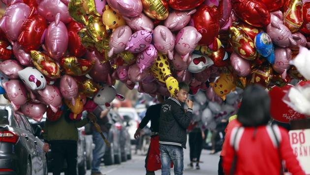 Vendors carry pig-shaped balloons for sale to mark the Lunar New Year in Hanoi, Vietnam. It is also the most important holiday in Vietnam, where it is celebrated as Tet. (Hau Dinh / AP) Vendors carry pig-shaped balloons for sale to mark the Lunar New Year in Hanoi, Vietnam. It is also the most important holiday in Vietnam, where it is celebrated as Tet. (Hau Dinh / AP)
