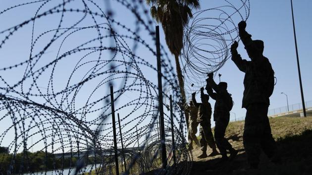 Members of the US military install multiple tiers of concertina wire along the banks of the Rio Grande near the Juarez-Lincoln Bridge at the U.S.-Mexico border, in Laredo, Texas on November 16. (AP File Photo) Members of the US military install multiple tiers of concertina wire along the banks of the Rio Grande near the Juarez-Lincoln Bridge at the U.S.-Mexico border, in Laredo, Texas on November 16. (AP File Photo)