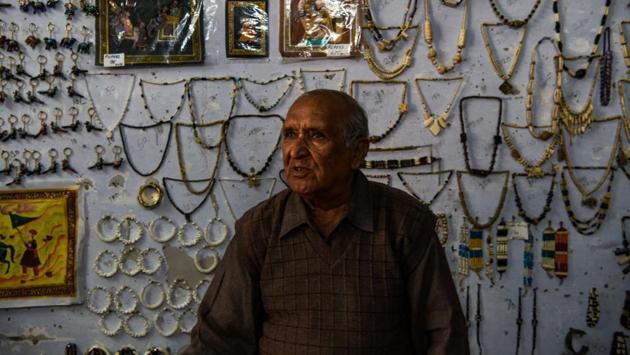 A shopkeeper sits inside his shop that sells various camel products at the camel research farm in Bikaner. Even the bones salvaged from dead camels are being utilised -- they are transformed into trinkets and souvenirs for tourists. (Chandan Khanna / AFP)