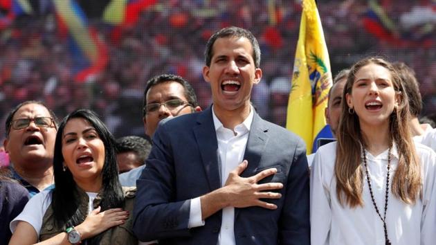 Venezuelan opposition leader and self-proclaimed interim president Juan Guaido and his wife Fabiana Rosales gesture during a rally against Venezuelan President Nicolas Maduro's government in Caracas, Venezuela February 2(REUTERS)