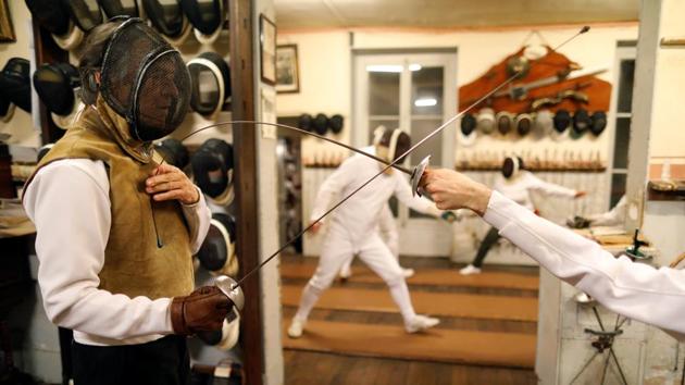 As is the tradition, each new student who arrives at the Salle d’Armes Coudurier faces the master of arms, Jean-Pierre Pinel de La Taule, and performs some exercises against his leather chest. (Charles Platiau / REUTERS)