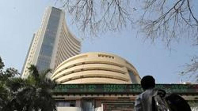 People look at a screen displaying the Sensex results on the facade of the Bombay Stock Exchange (BSE) building in Mumbai, India, December 11, 2018. REUTERS/Francis Mascarenhas/File Photo(REUTERS)