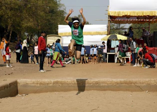 Jhanvi Chorghe of under-12 category in action at the long jump event at the Maharashtriya Mandal’s Chandrashekar Agashe College of physical education ground on Friday. (RAHUL RAUT/HT PHOTO) 