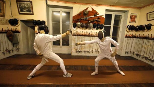 Members attend a training session at the Salle d’Armes Coudurier. The club still lives by the epithets of ‘classic’ fencing, a different game compared to the modern sporting style. The perfection of the gestures and a harmonious execution is valued over sheer physical effort. (Charles Platiau / REUTERS)