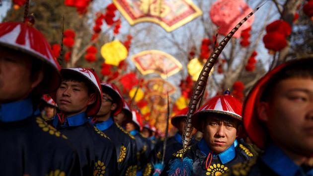 In Beijing, performers in traditional Qing dynasty robes strummed zithers for a re-enactment at sunrise of a sacrificial ceremony at the Chinese capital’s Temple of Earth park. An actor portraying an emperor bowed before an altar as dozens of people in ceremonial dress behind him. (Thomas Peter / Reuters) In Beijing, performers in traditional Qing dynasty robes strummed zithers for a re-enactment at sunrise of a sacrificial ceremony at the Chinese capital’s Temple of Earth park. An actor portraying an emperor bowed before an altar as dozens of people in ceremonial dress behind him. (Thomas Peter / Reuters)