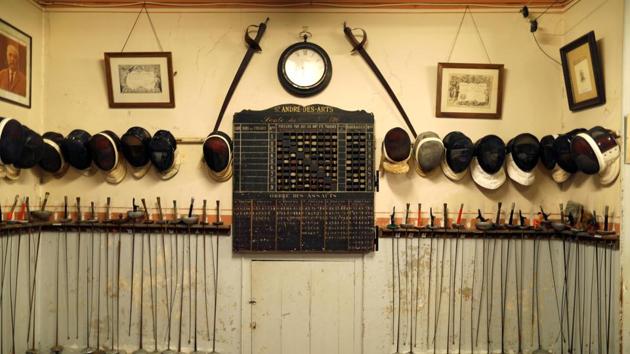 Masks and vintage epees are displayed along with an old school leaderboard at the Salle d’Armes Coudurier. The club, located in the Latin Quarter of Paris, is open to everyone. (Charles Platiau / REUTERS)