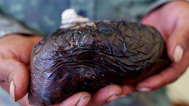 Poppy farmer Santiago Sanchez holds opium paste in Santa Cruz Yucucani in the Sierra Madre del Sur. That, along with a trend toward mixing synthetic opiate fentanyl in Mexico’s tarry black heroin, has slashed what criminal gangs pay farmers like Sanchez for a kilo of opium. Now, Sanchez earns about $260 per kilo, a fifth of the average price two years ago. (Carlos Jasso / REUTERS)