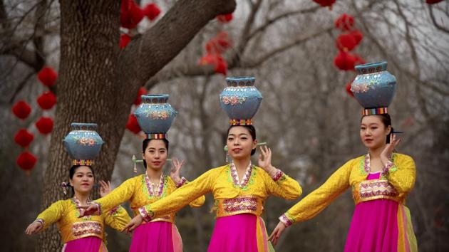 Dancers in traditional ethnic clothing perform at a temple fair at Longtan Park in Beijing, China. (Mark Schiefelbein / AP)